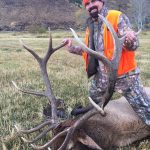 Bill Busbice poses with a bull elk killed on his ranch in Wyoming